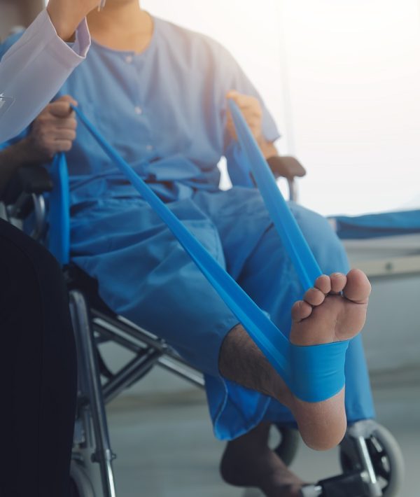 A physiotherapist doing treatment with patient in bright office